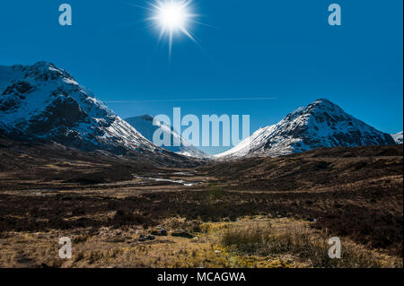 Breathtaking views of the Scottish Highlands - a bright sunshine shines down on the beautiful mountains of Glencoe Stock Photo