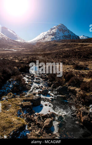 Breathtaking views of the Scottish Highlands - a bright sunshine shines down on the beautiful mountains of Glencoe Stock Photo