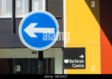 A one way sign to the left and a sign towards the Barbican Centre on the right Stock Photo
