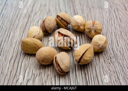 Pistachios on wooden table in a cirle shape. Stock Photo