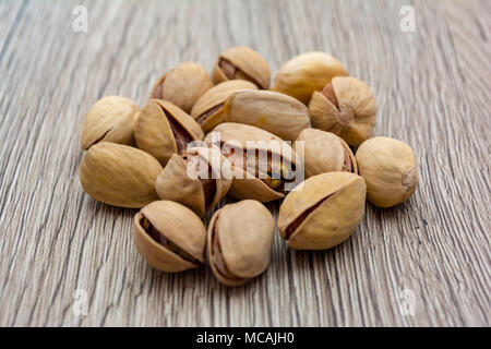 Pistachios on wooden table in a cirle shape. Stock Photo