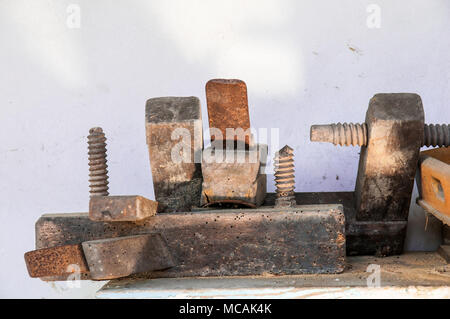 old woodworking tools on the white wall, close-up view, still life Stock Photo