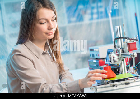 A young woman design a model of an artificial organ on a 3D printer Stock Photo