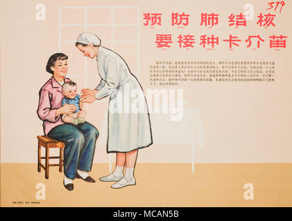 young mother in a pink stripe shirt holds a baby boy who is receiving a vaccine shot from a nurse dressed in white.