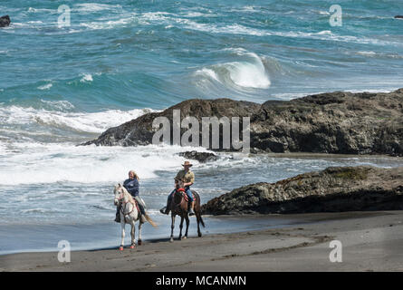 Horseback riders from Ricochet Ridge Ranch enjoy Ten Mile Beach on the Pacific Coast in Fort Bragg, California Stock Photo