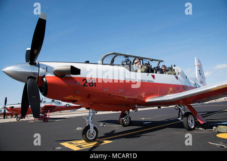 180201-D-OT909-085  CORPUS CHRISTI, Texas (Feb. 1, 2018) Lt. Cmdr. Scott Urbashich, an instructor pilot assigned to Training Squadron 28 (VT-28), left, and Capt. Trey Hayden, Training Air Wing (TRAWING) 4 Commodore, preflight the last T-6B Texan II in production aboard Naval Air Station (NAS) Corpus Christi. NAS Corpus Christi aquired the plane from Beechcraft, making it the 97th plane in the base's fleet. (U.S. Navy Photo by Anne Booher/Released) Stock Photo