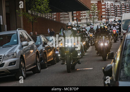 London, UK. 14th April 2018. Bikers from the Ace Cafe including Muslim bikers Deen Riders and others took part in a United Ride 4 Grenfell, from the Ace Cafe on the North Circular Rd, riding to Parliament and then coming to Kensington Town Hall.  They rode past the crowd waiting to start the march from the town hall to cheers and applause, making a loud noise. The montly silent walk marking 10 months since the Grenfell fire disaster began immediately after the ried-past. Peter Marshall/Alamy Live News Stock Photo