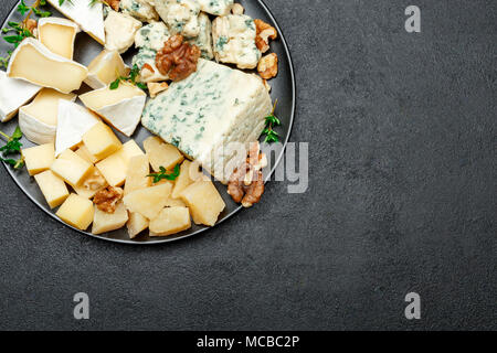 various types of cheese in dark plate Stock Photo