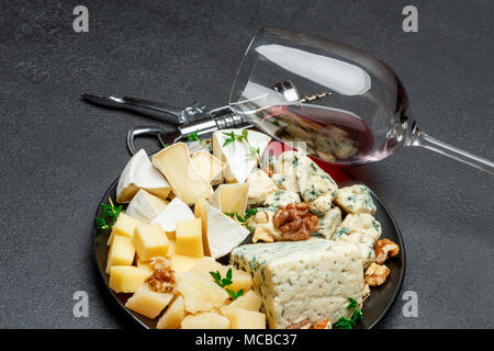 various types of cheese in dark plate Stock Photo