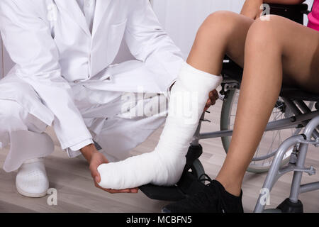 Close-up Of Doctor's Hand Holding Disabled Woman's Leg In Clinic Stock Photo