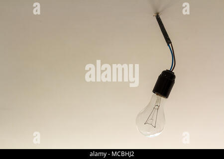 Close up picture of isolated electric light bulb on gray abstract background. Energy saving and economy concept. Stock Photo