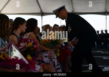 SAN DIEGO (March 30, 2018) The family members of Capt. Matthew McGonigle, a native of Turnersville, New Jersey, are presented flowers during a change of command ceremony for Commander, Littoral Combat Ship Squadron One (COMLCSRON ONE). During the ceremony, McGonigle relieved Capt. Jordy Harrison, a native of Columbia, Maryland, as commander, COMLCSRON ONE, making McGonigle the ninth commodore of the squadron. Stock Photo