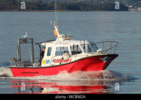 The Firth of Clyde-based Coegfran II, used in various roles such as a dive boat, fishing boat, or for sight-seeing tours, passes East India Harbour. Stock Photo