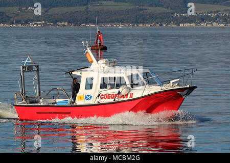 The Firth of Clyde-based Coegfran II, used in various roles such as a dive boat, fishing boat, or for sight-seeing tours, passes East India Harbour. Stock Photo