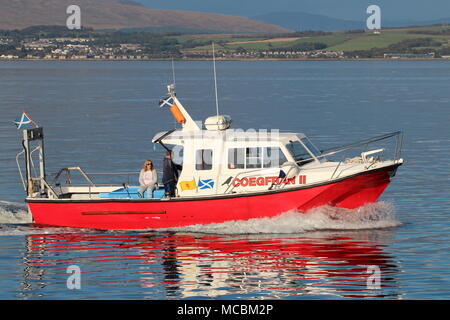 The Firth of Clyde-based Coegfran II, used in various roles such as a dive boat, fishing boat, or for sight-seeing tours, passes East India Harbour. Stock Photo