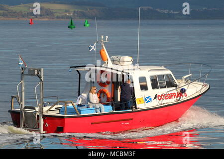 The Firth of Clyde-based Coegfran II, used in various roles such as a dive boat, fishing boat, or for sight-seeing tours, passes East India Harbour. Stock Photo