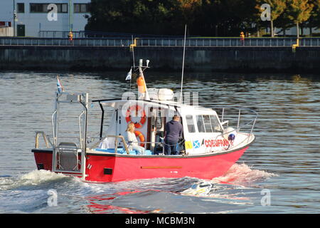 The Firth of Clyde-based Coegfran II, used in various roles such as a dive boat, fishing boat, or for sight-seeing tours, passes East India Harbour. Stock Photo