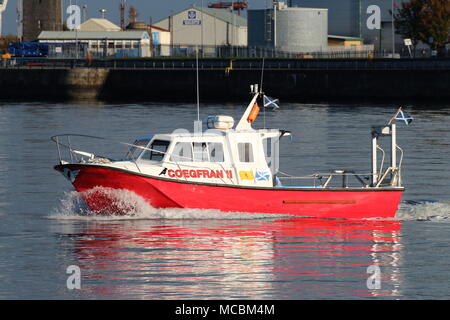 The Firth of Clyde-based Coegfran II, used in various roles such as a dive boat, fishing boat, or for sight-seeing tours, passes East India Harbour. Stock Photo