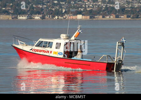 The Firth of Clyde-based Coegfran II, used in various roles such as a dive boat, fishing boat, or for sight-seeing tours, passes East India Harbour. Stock Photo