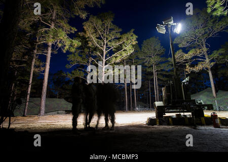 U.S. Marines with 2nd Transportation Support Battalion, 2nd Marine Logistics Group, walk through the command operations center during Bold Bronco 18 on Fort Bragg, N.C., March 23, 2018. Bold Bronco 18 was an annual battalion sized training exercise held to promote force readiness. Stock Photo