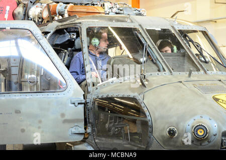 (From left to right) Mr. Donald Camp, a  Logistics Assistance Representatives (LARs), with the United States Army Aviation and Missile Command (AMCOM) and Spc. Damian Murry from C Company, 2-227th Aviation Regiment, 1st Air Cavalry Brigade from Fort Hood Texas conducts main rotor system maintenance on a HH-60 MEDEVAC helicopter, March 27, 2018, at Katterbach Army Airfield in Ansbach, Bavaria, Germany. LARs are the technical experts who have the skills and experience to provide technical assistance for on-site repairs to increase readiness and reduce cost. The LARs work closely with the units t Stock Photo