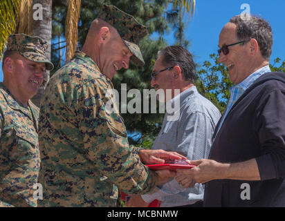 U.S. Marine Col. Gary S. Johnston, deputy commanding general, Marine Corps Installations - West, Marine Corps Base Camp Pendleton, presents the Federal Length of Service award to Michael Randolph for 40 years of service on Camp Pendleton, Calif., March 29, 2018. The Federal Length of Service award is awarded to civilians at 30, 35, and 40 years of service in grateful recognition of faithful service to the federal government. Stock Photo