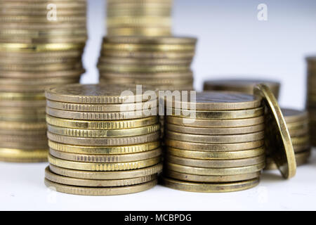 Coins stacked. Money lying on the table. White background. Stock Photo