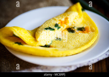 omelette from chicken eggs with green onion Stock Photo