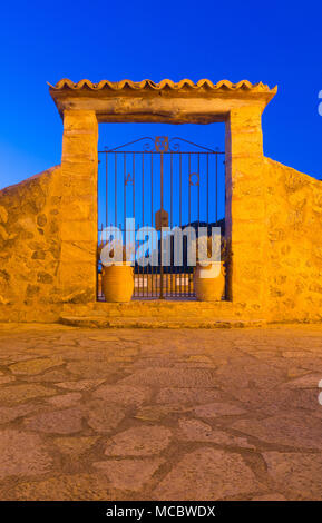 Gateway of the Iglesia de San Juan Bautista church against an evening sky in Deia, Mallorca, Spain. Stock Photo