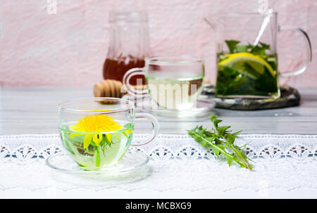 Dandelion herbal tea and fresh flowers on a table Stock Photo