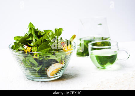 Dandelion salad in a bowl and herbal tea Stock Photo