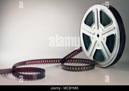 Old motion picture film reel on brown background Stock Photo