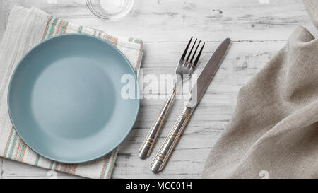 Empty grey plate on light wooden background Stock Photo