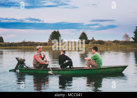 Teenage boys fishing in river at sunset, Washington, USA Stock