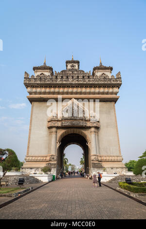 Tourists at the Patuxai (Victory Gate or Gate of Triumph) war monument in Vientiane, Laos, on a sunny day. Stock Photo
