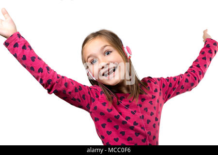 Little happy girl with headphones having fun listening to the music, isolated on white. Stock Photo