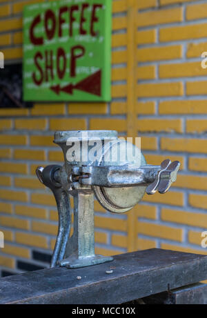 A manual coffee grinder in front of a coffee shop. Minca, Colombia, South America. Stock Photo