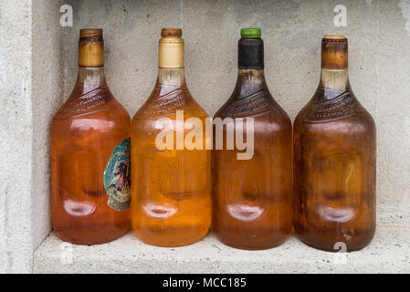 Antique glass gasoline bottles at a rural petro station. Colombia, South America. Stock Photo