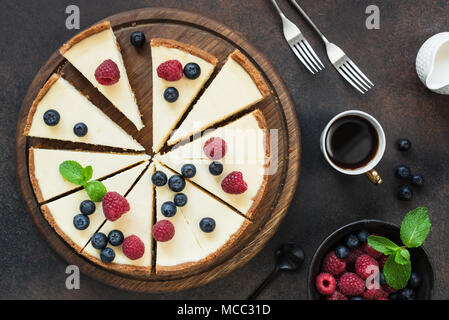 Top view of cheesecake with summer berries on dark background. Horizontal composition Stock Photo