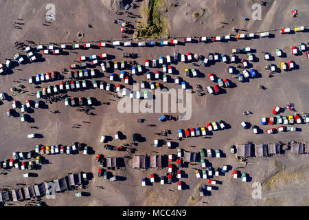 Aerial view of tourist jeeps waiting for people at parking lot in Bromo volcano, Indonesia Stock Photo