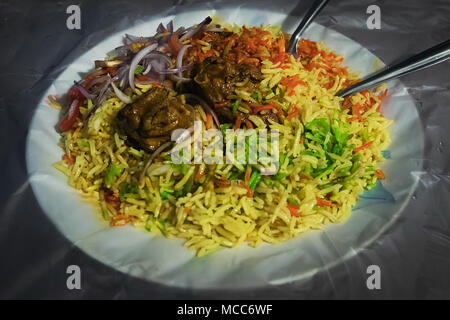 Special Mutton kacchi biryani Rice with chili onion lime on a plate. Traditional Indian cuisine. Briani. Multicolored rice in a plate Stock Photo