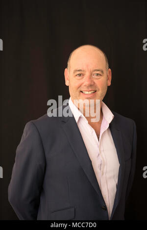A slightly overweight businessman dressed in business casual clothes with no tie Stock Photo