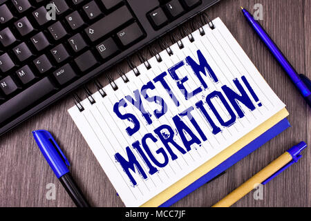 Word writing text System Migration Motivational Call. Business concept for Moving programs to another platform written Notepad wooden grey background  Stock Photo