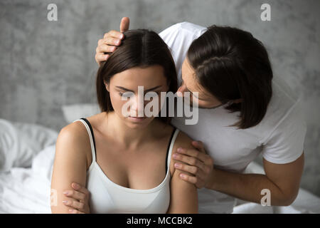 Loving man apologizing resentful sulky woman feeling offended after conflict, boyfriend asking upset capricious girlfriend for forgiveness excusing to Stock Photo