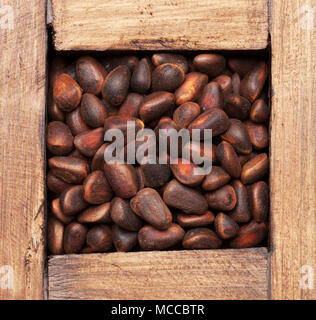 Pine nuts in wooden box. Top view Stock Photo