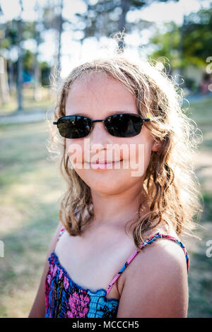 Summer portrait of young girl wearing sunglasses. Stock Photo