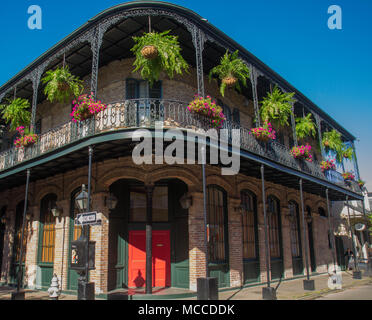 French flag hanging from cast iron balcony on a building in the French Quarter, New Orleans, Louisisana, United States. Stock Photo