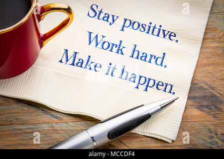Stay positive. Work hard. Make it happen.  Inspirational handwriting on a napkin. Stock Photo