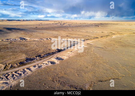 Trail winding through prairie in northern Colorado, early spring aerial view Stock Photo