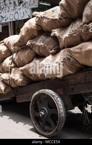 Over-laden hand cart with sacks full of charcoal on Nagdevi street near Crawford Market in Mumbai Stock Photo